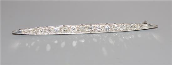 A mid 20th century white metal and graduated diamond set bar brooch, 76mm.